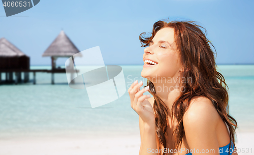 Image of happy beautiful woman on tropical beach