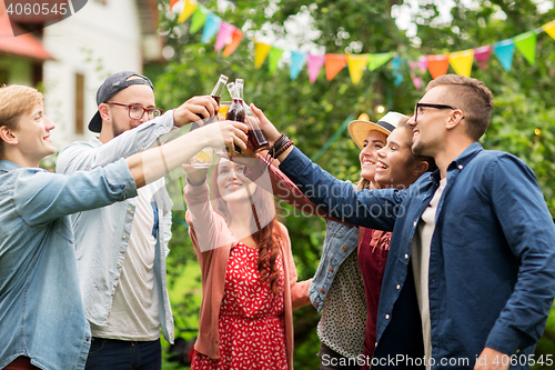 Image of happy friends clinking glasses at summer garden