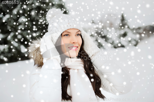 Image of happy woman outdoors in winter clothes