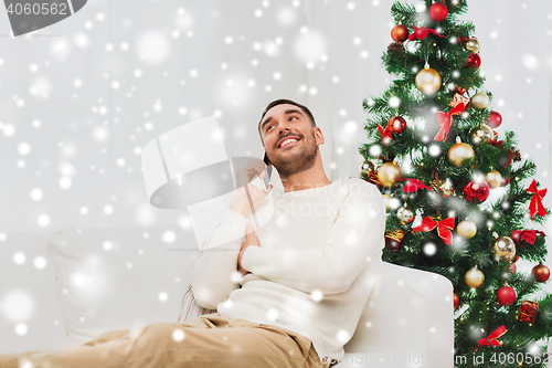 Image of man calling on smartphone at home for christmas