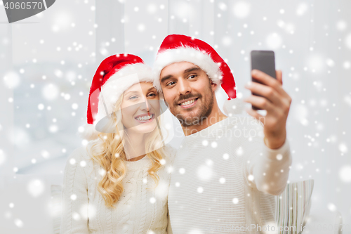 Image of couple taking selfie with smartphone at christmas