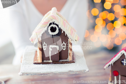 Image of close up of woman showing gingerbread house