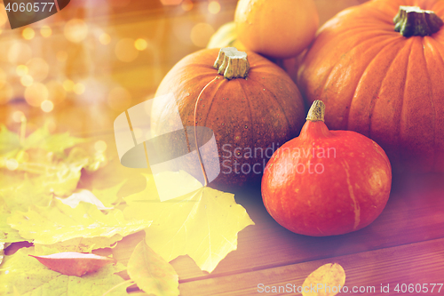 Image of close up of pumpkins on wooden table at home
