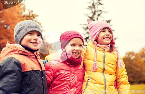 Image of group of happy children hugging in autumn park