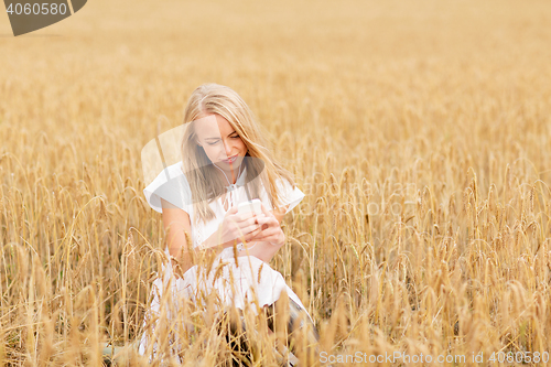 Image of happy woman with smartphone and earphones