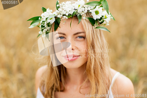 Image of happy woman in wreath of flowers