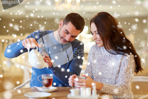 Image of happy couple drinking tea at cafe