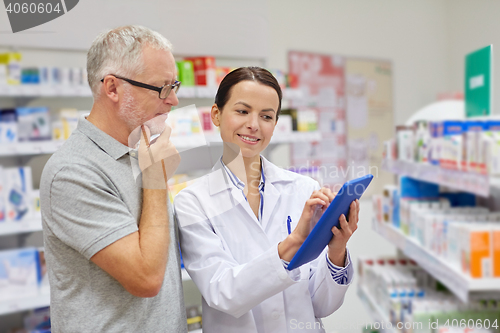 Image of pharmacist with tablet pc and senior man