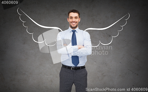 Image of happy businessman with angel wings over gray