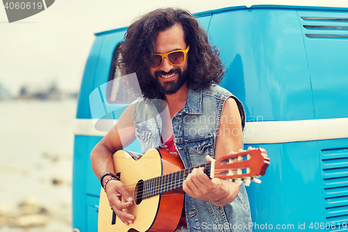 Image of hippie man playing guitar over minivan car outdoor