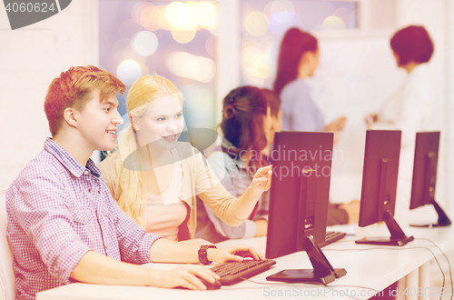 Image of students with computer monitor at school
