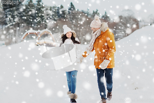 Image of happy couple walking over winter background