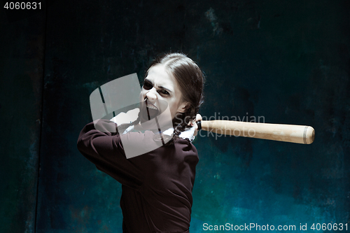 Image of Portrait of a young girl in school uniform as killer woman