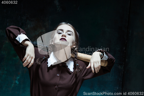 Image of Portrait of a young girl in school uniform as killer woman