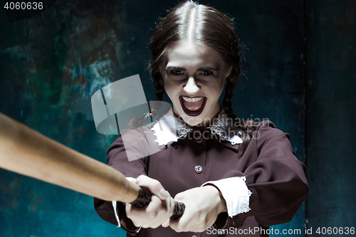 Image of Portrait of a young girl in school uniform as killer woman