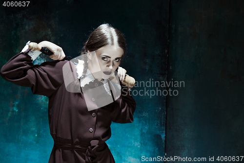 Image of Portrait of a young girl in school uniform as killer woman