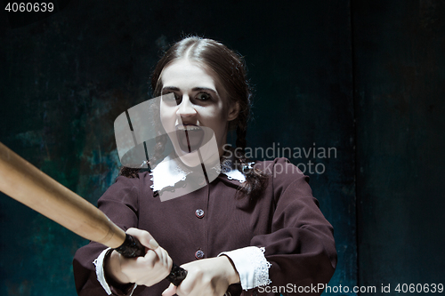 Image of Portrait of a young girl in school uniform as killer woman