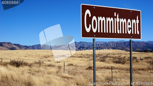 Image of Commitment brown road sign