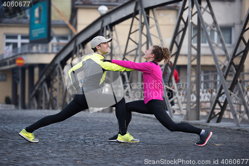 Image of couple warming up before jogging