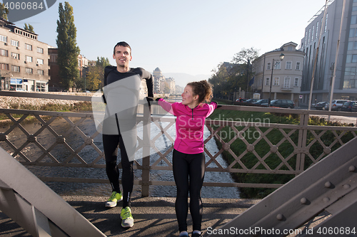 Image of couple warming up before jogging