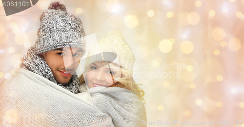 Image of happy family couple in winter clothes hugging