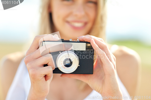 Image of close up of woman photographing with film camera