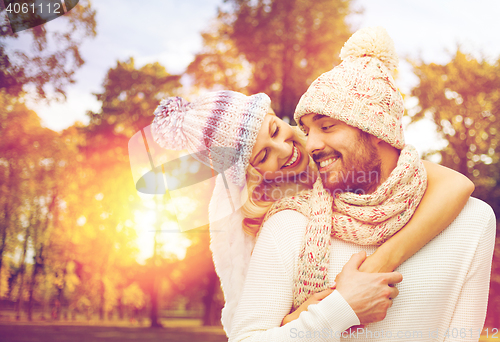 Image of happy couple in warm clothes over autumn