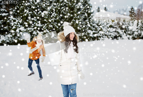 Image of happy couple playing snowballs in winter