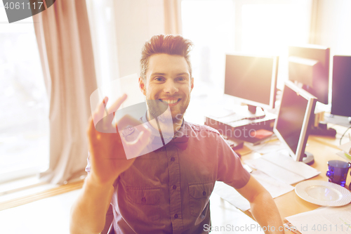 Image of happy creative male office worker showing ok sign