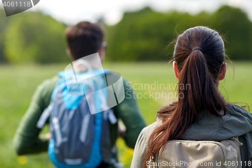 Image of close up of couple with backpacks hiking outdoors