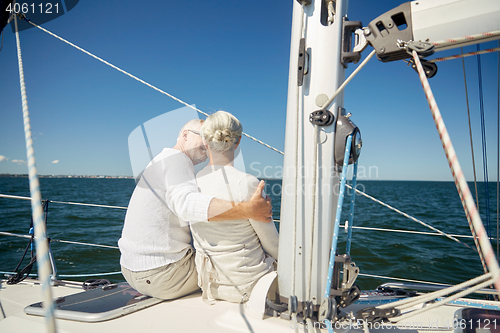 Image of senior couple hugging on sail boat or yacht in sea