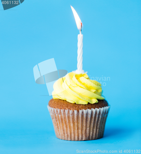 Image of birthday cupcake with one burning candle