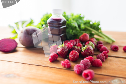 Image of bottle with beetroot juice, fruits and vegetables