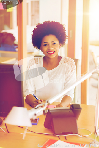 Image of businesswoman with computer and phone at office