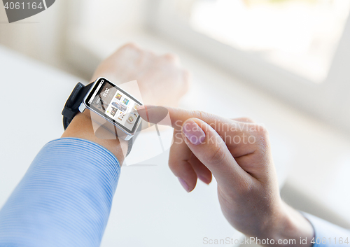 Image of close up of hands with blog on smart watch screen