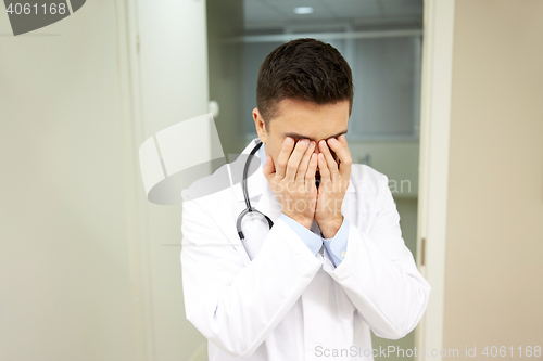 Image of sad or crying male doctor at hospital ward