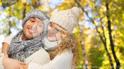 Image of happy couple in warm clothes over autumn