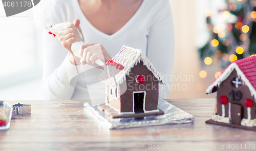 Image of close up of woman making gingerbread houses