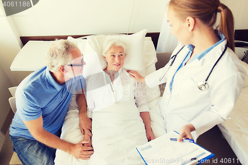 Image of senior woman and doctor with clipboard at hospital