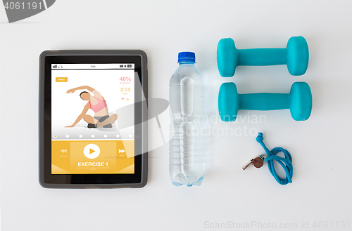 Image of tablet pc, dumbbells, whistle and water bottle