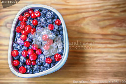 Image of Blueberries And Cranberry In A Cup