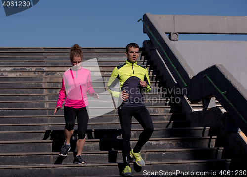 Image of young  couple jogging on steps