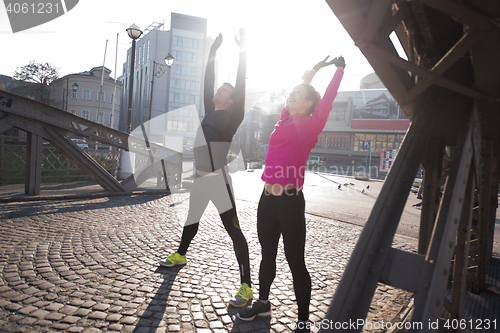 Image of couple warming up before jogging