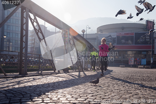 Image of sporty woman jogging on morning