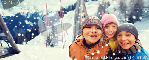 Image of happy children hugging over winter background