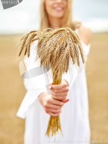 Image of close up of happy woman with cereal spikelets