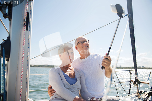 Image of senior couple taking selfie on sail boat or yacht