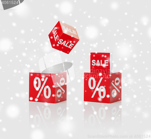 Image of red boxes with sale and percent sign over snow