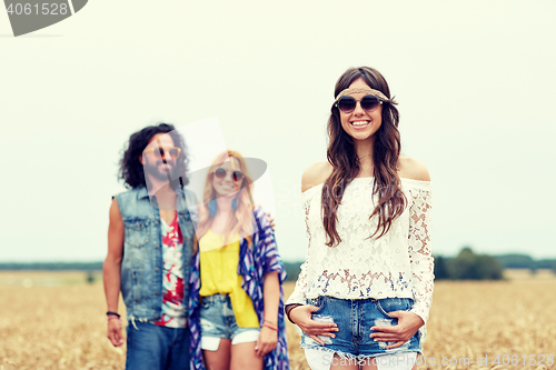 Image of smiling young hippie friends on cereal field