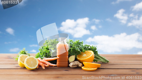 Image of bottle with carrot juice, fruits and vegetables